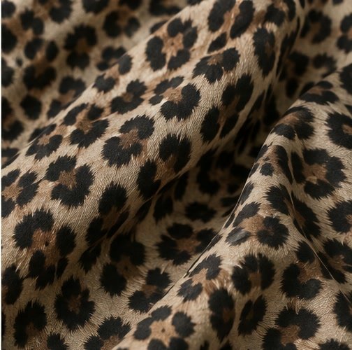 Leopard fabric pattern swatch with irregular dark rosettes