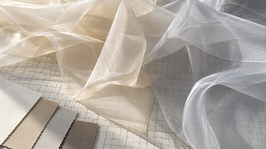 Silk organza and polyester organza swatches layered over a grid with stiffness, transparency and edge notes