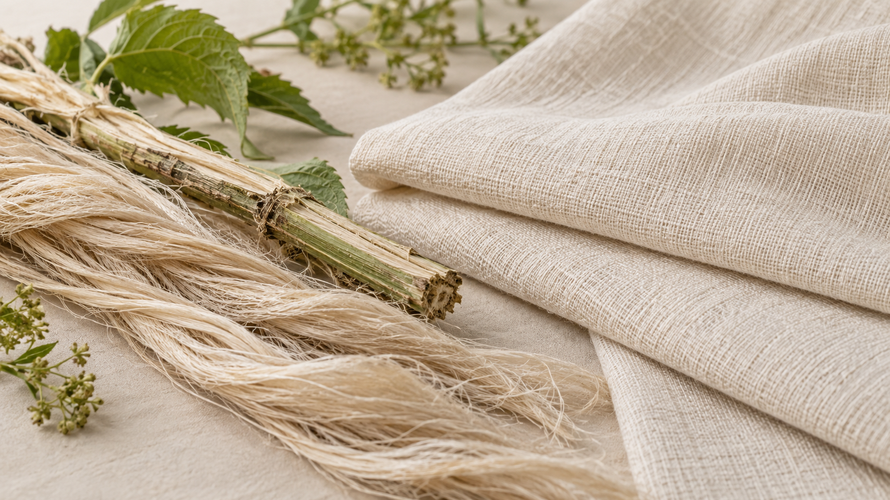Ramie bast fibre beside folded natural ramie fabric